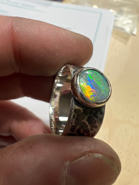 1.1 ct dark opal set in a silver ring