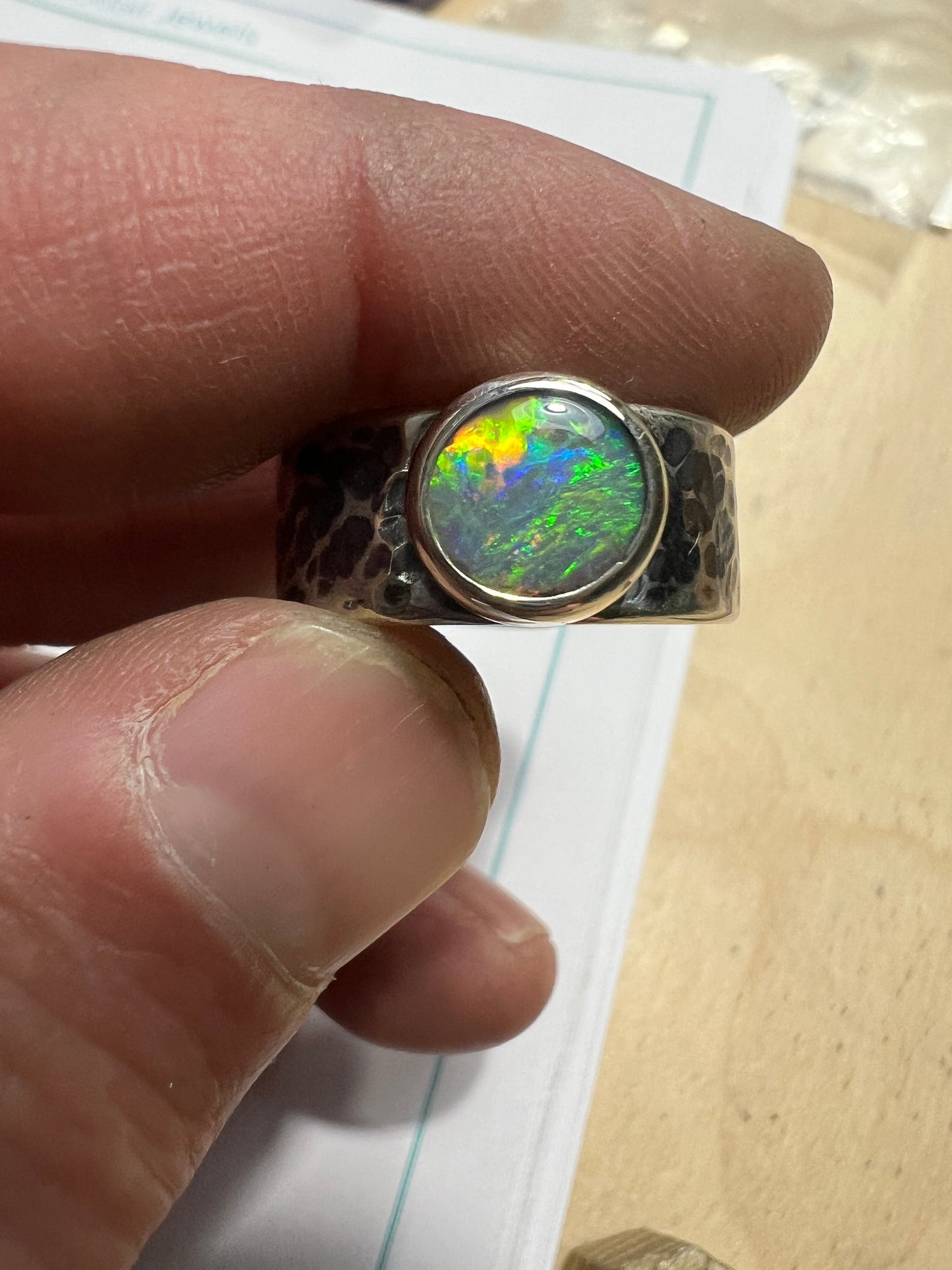 1.1 ct dark opal set in a silver ring